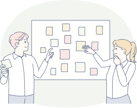 ホワイトボードを指さしている男性と女性